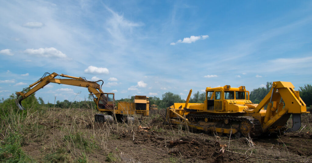 land clearing equipment plowing field